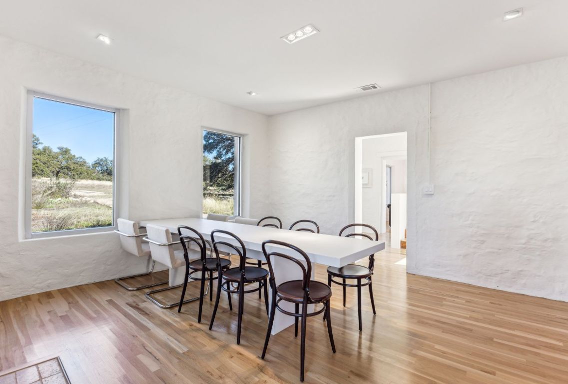 1037 Ranch Road 962 West Round Mountain, TX 78663 - Photo 9 of 40 a view of a a dining room with furniture window and wooden floor