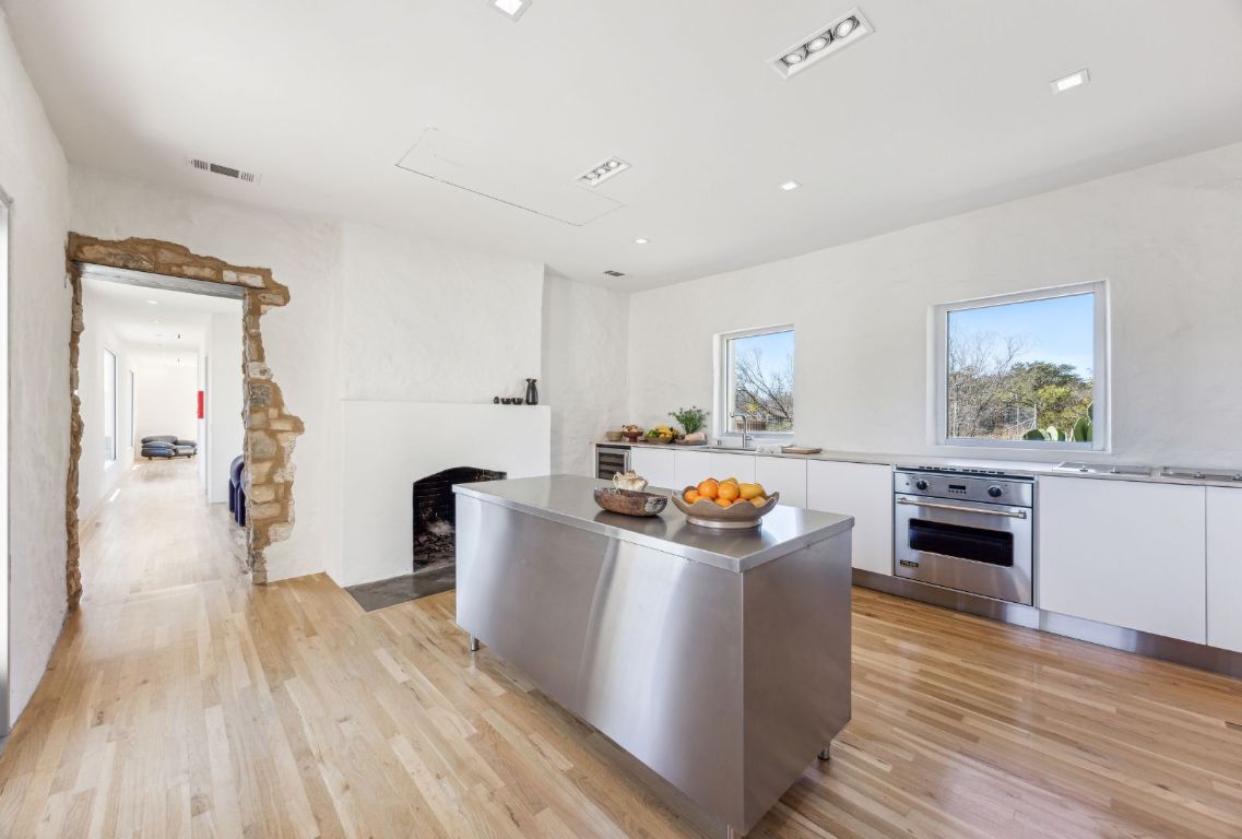 1037 Ranch Road 962 West Round Mountain, TX 78663 - Photo 10 of 40 a living room with a stove and wooden floor