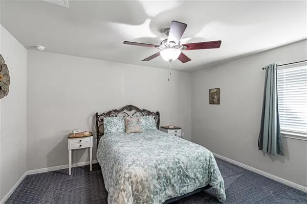 a bathroom with a sink a toilet a mirror and shower curtain