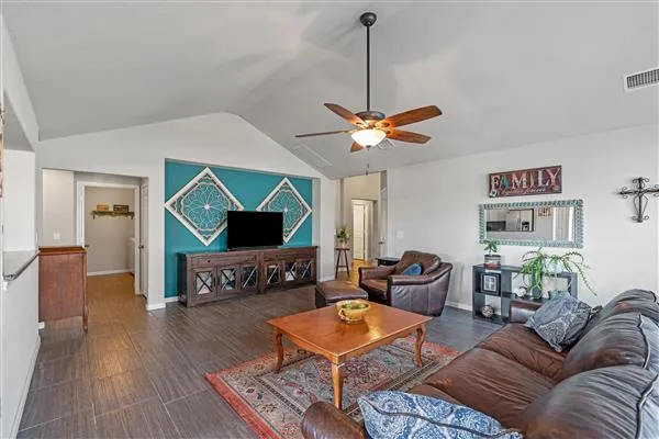 a living room with furniture and a chandelier