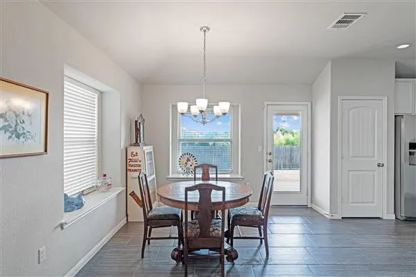 a kitchen with cabinets stainless steel appliances and wooden floor