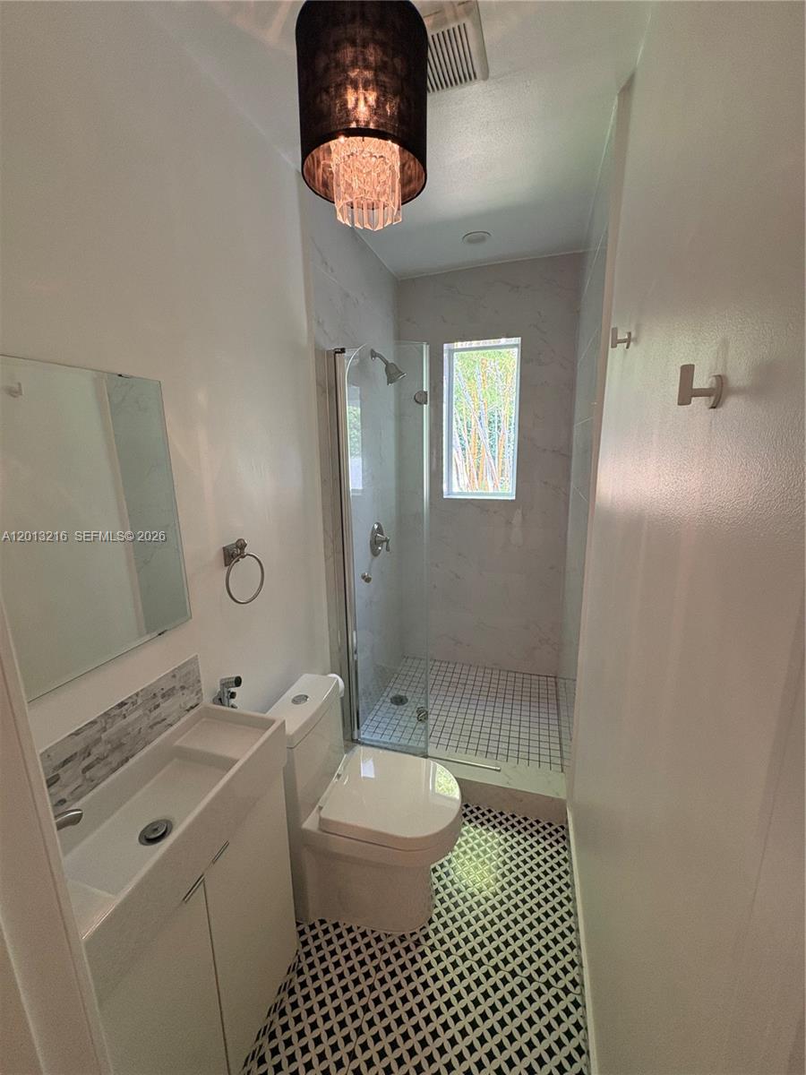 250 Southwest 19th Road Miami, FL 33129 - Photo 11 of 22 a bathroom with a sink a toilet and shower