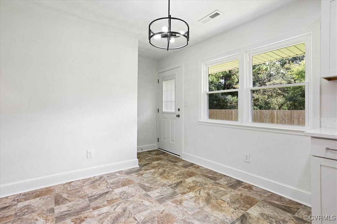 113 Beaver Dam Road Waverly, VA 23890 - Photo 11 of 34 Doorway to outside with an inviting chandelier