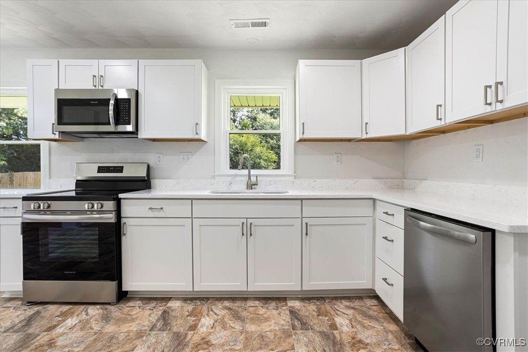 113 Beaver Dam Road Waverly, VA 23890 - Photo 13 of 34 Kitchen with white cabinets, appliances with stain