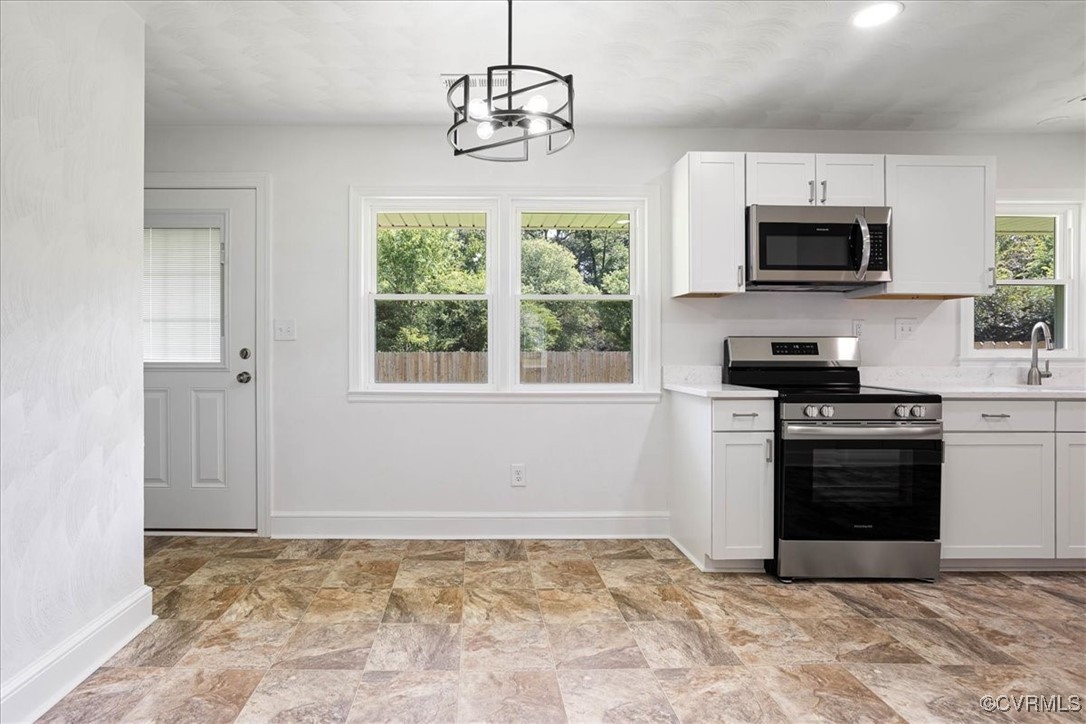 113 Beaver Dam Road Waverly, VA 23890 - Photo 9 of 34 Kitchen featuring a healthy amount of sunlight, ha