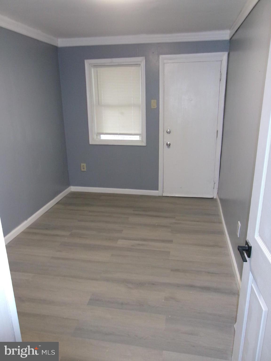 1017 Barker Road Sharon Hill, PA 19079 - Photo 11 of 20 a view of an empty room with wooden floor and a window
