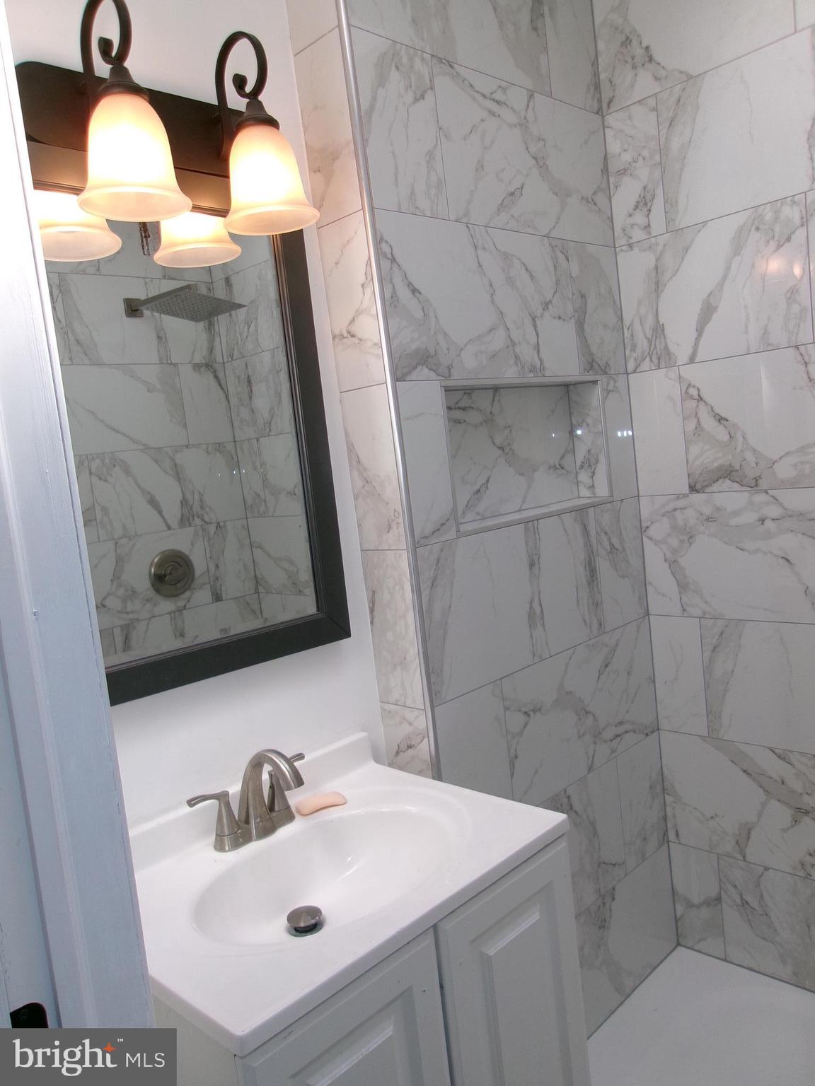 1017 Barker Road Sharon Hill, PA 19079 - Photo 12 of 20 a bathroom with a sink and mirror