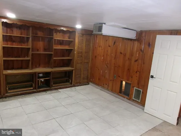 a view of an empty room with empty shelves
