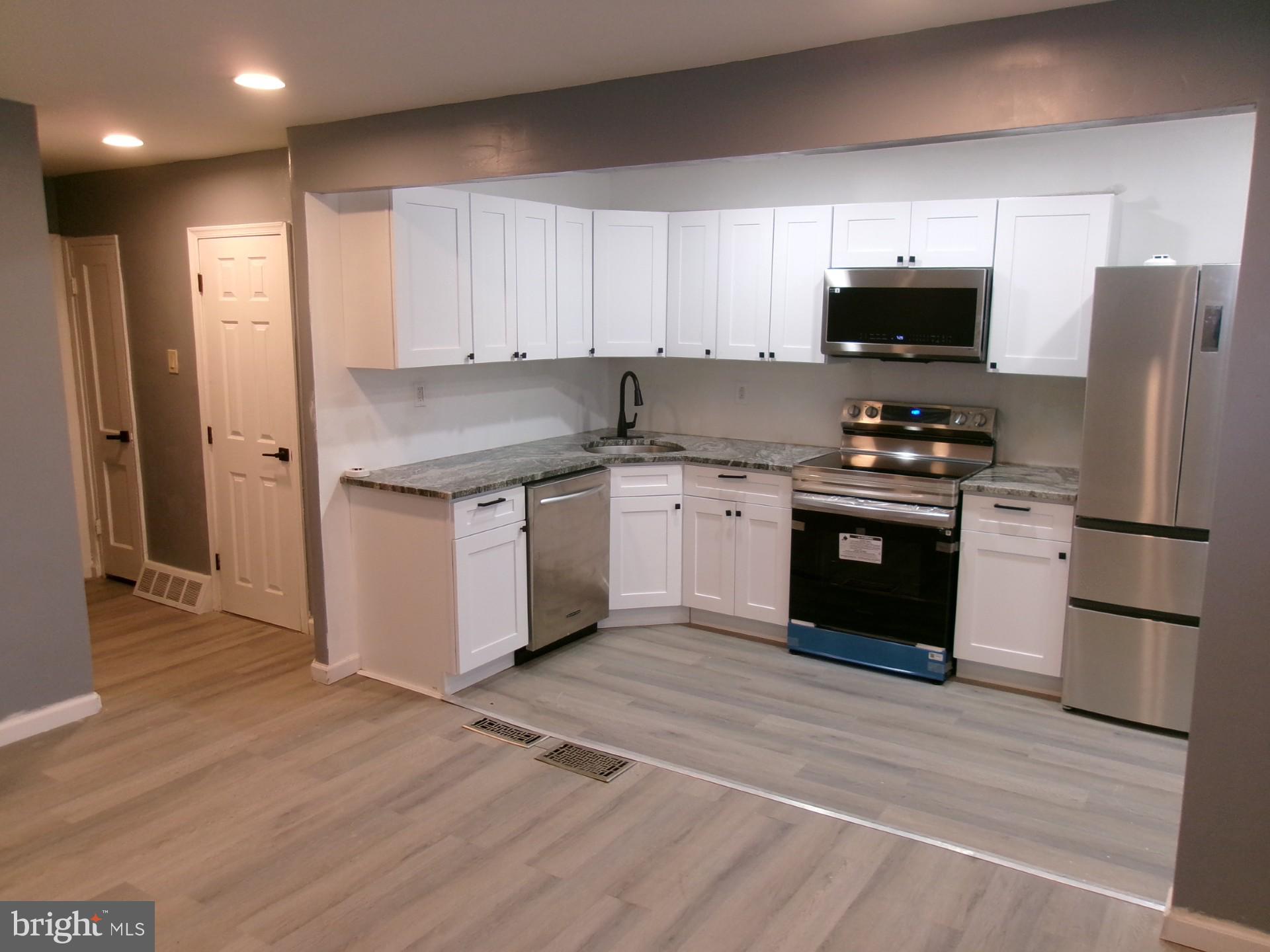 1017 Barker Road Sharon Hill, PA 19079 - Photo 3 of 20 a kitchen with stainless steel appliances granite countertop a stove sink and refrigerator