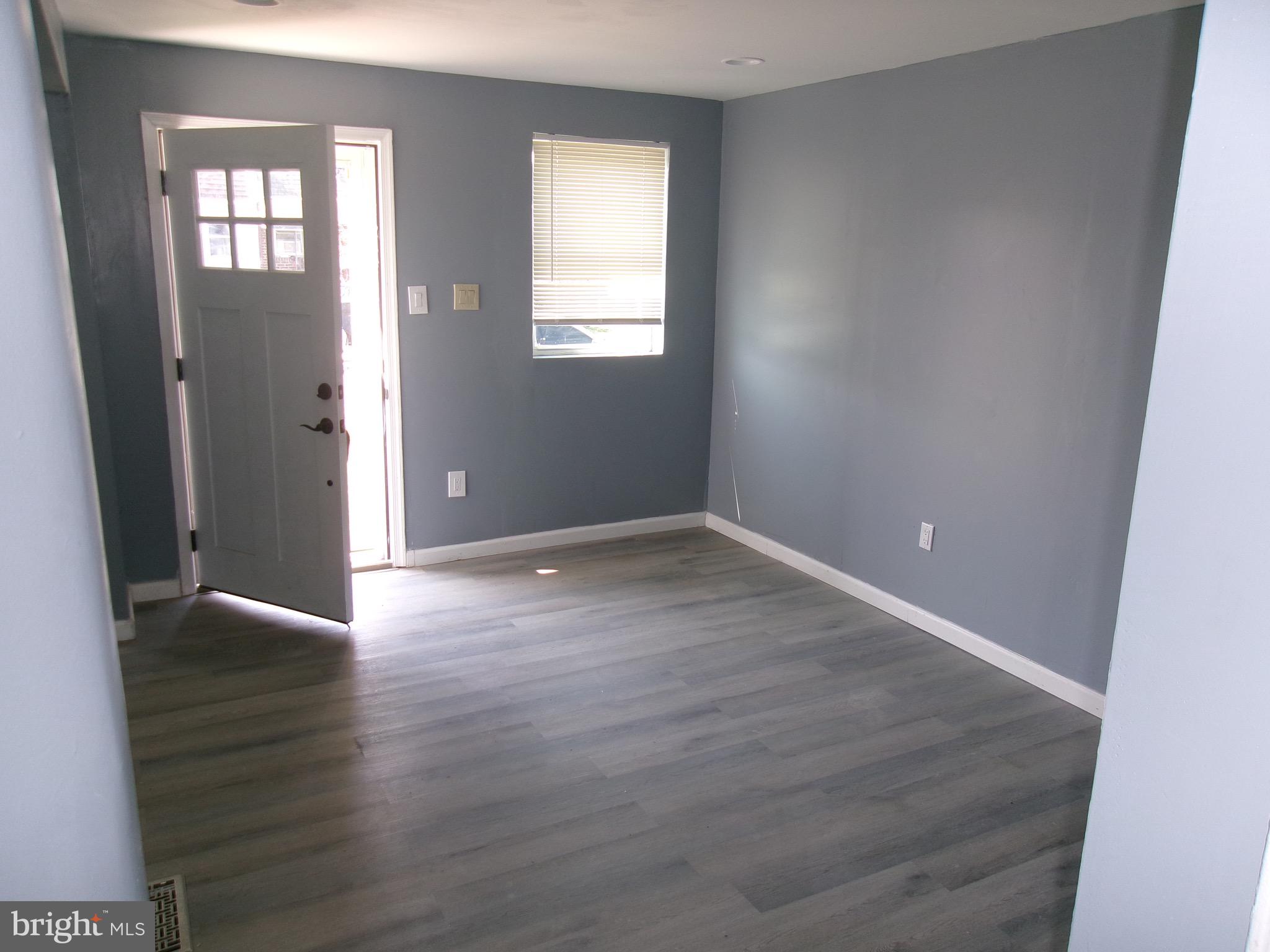 1017 Barker Road Sharon Hill, PA 19079 - Photo 6 of 20 an empty room with wooden floor and windows
