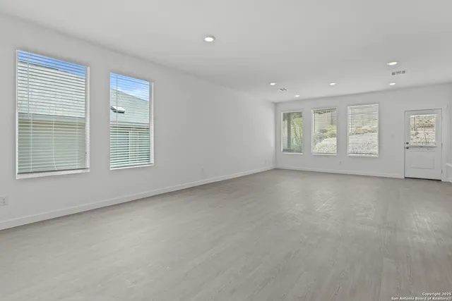 a living room with furniture and view of kitchen