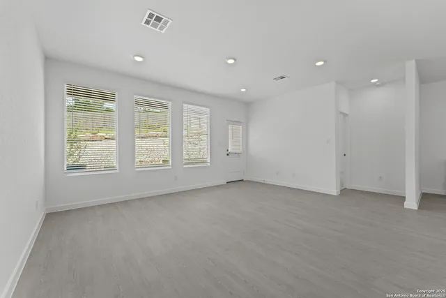 a kitchen with white cabinets and black stainless steel appliances