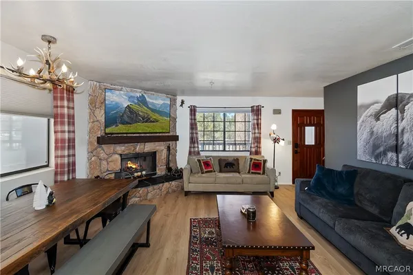 a living room with fireplace furniture and a flat screen tv