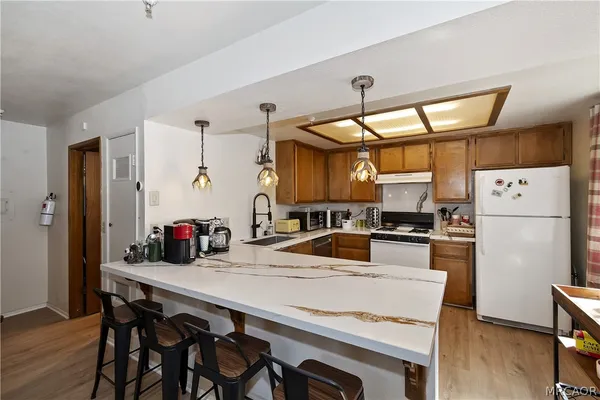 a kitchen with refrigerator cabinets dining table and chairs