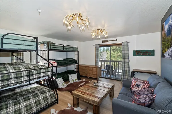 a bedroom with furniture and a chandelier