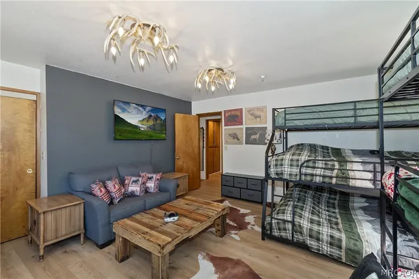 a bedroom with a bed and a painting on the wall