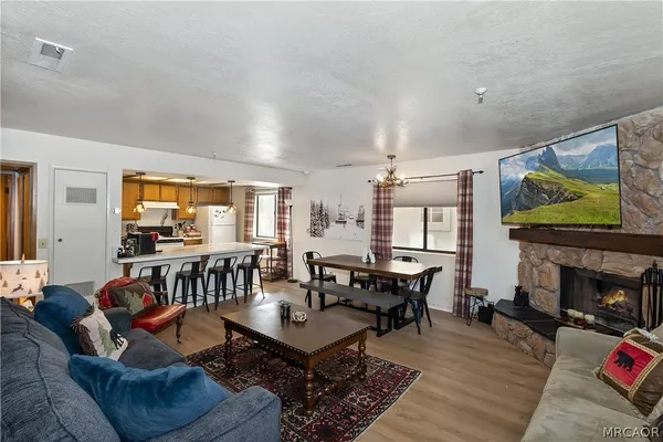 a living room with fireplace furniture and a flat screen tv