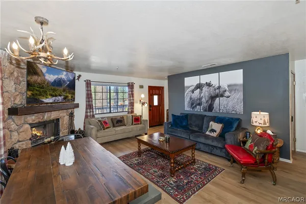 a living room with furniture a flat screen tv and a fireplace