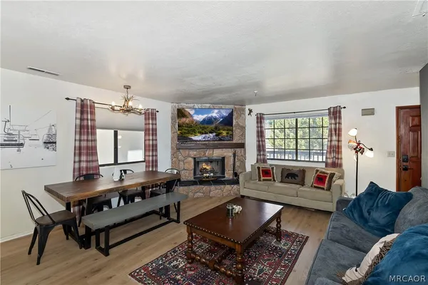 a living room with furniture fireplace and flat screen tv