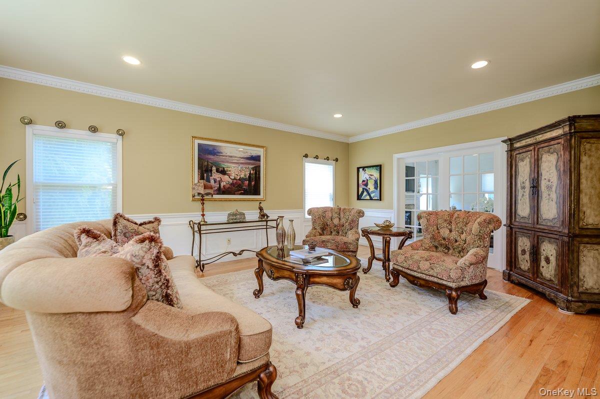 129 Round Swamp Road Huntington, NY 11743 - Photo 7 of 49 Living space featuring light wood-finish flooring, white crown molding, recessed lighting, and a chair rail