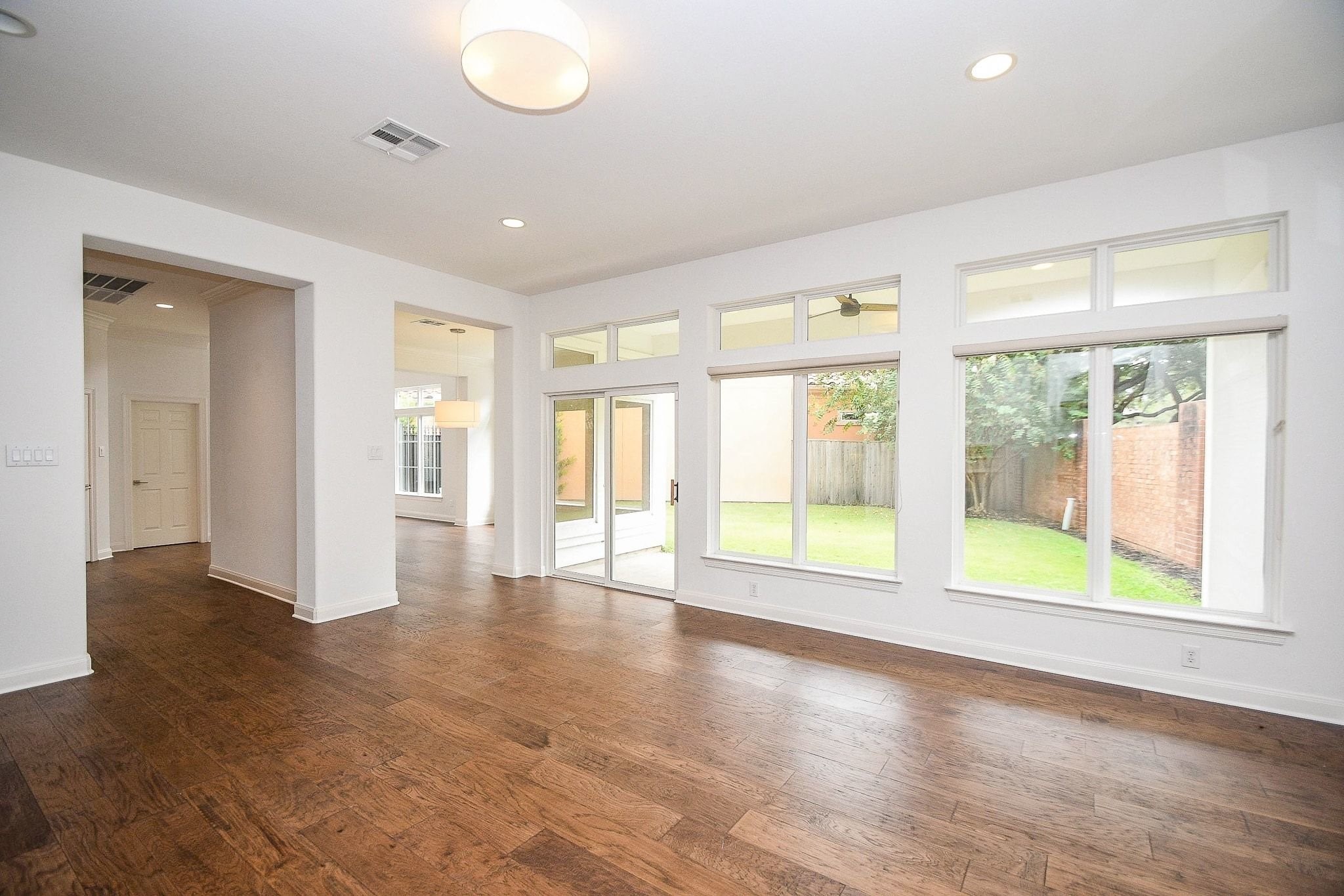 2826 Tudor Manor Houston, TX 77082 - Photo 6 of 37 This spacious family room features modern accent finishes, gleaming wood floors, and a beautiful view of the covered patio and expansive side yard.