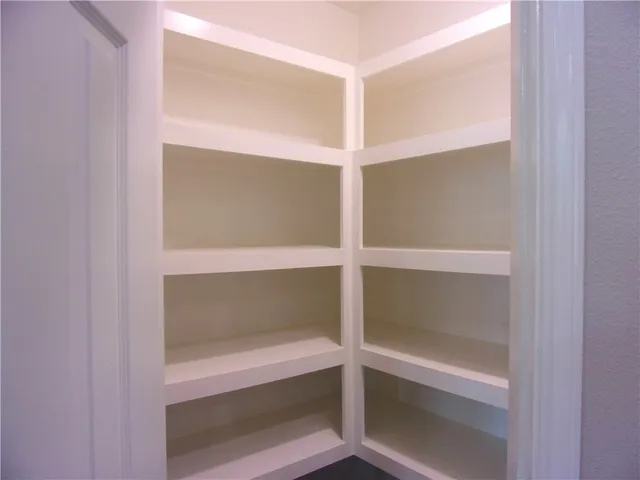 a view of kitchen with granite countertop cabinets and wooden floor