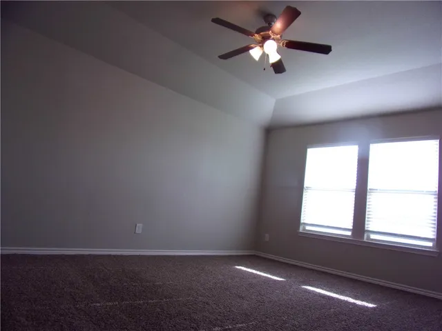 a bathroom with a shower and a glass door