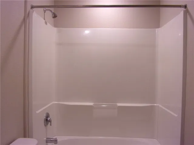 a view of an empty room and a window