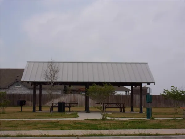 a view of a patio with table and chairs