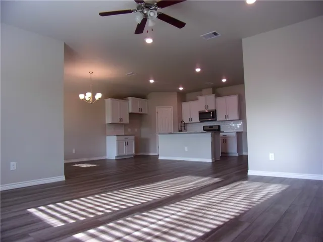 a view of kitchen with cabinets and wooden floor