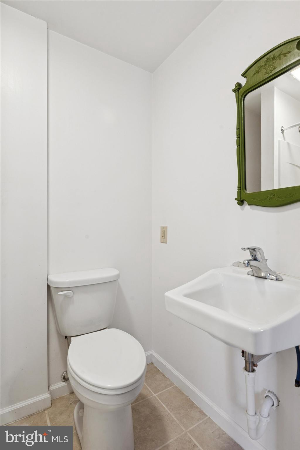 613 Convent Road Aston, PA 19014 - Photo 21 of 25 a bathroom with a sink mirror and toilet