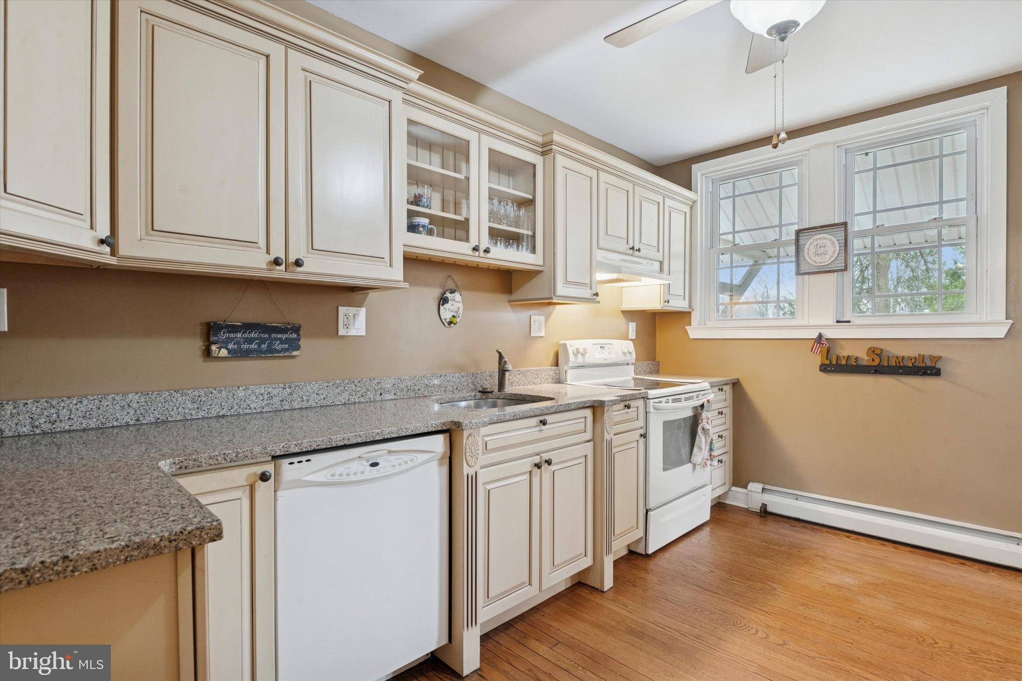 613 Convent Road Aston, PA 19014 - Photo 10 of 25 a kitchen with stainless steel appliances granite countertop white cabinets a sink and dishwasher with wooden floor