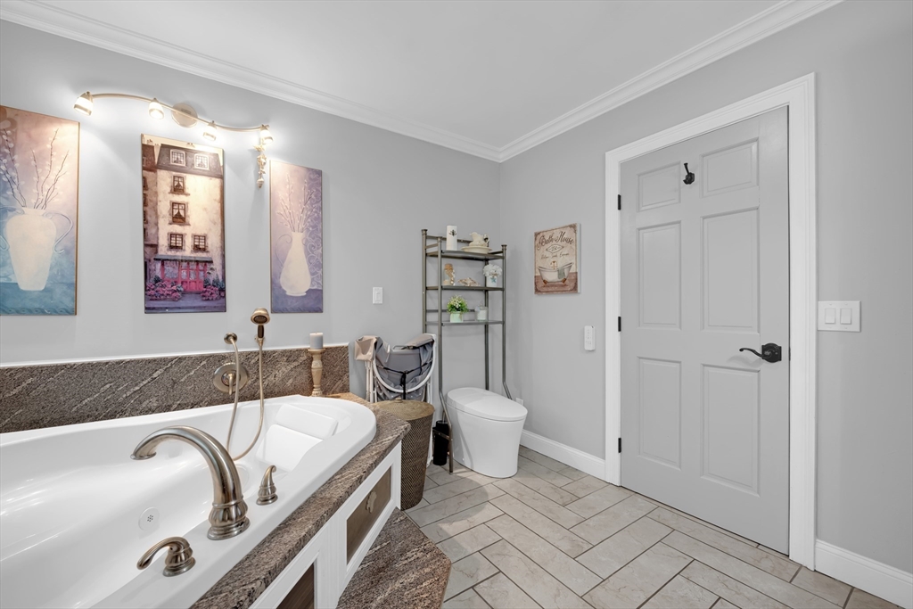156 Olean Street Worcester, MA 01602 - Photo 11 of 37 a bathroom with a granite countertop sink mirror vanity and toilet