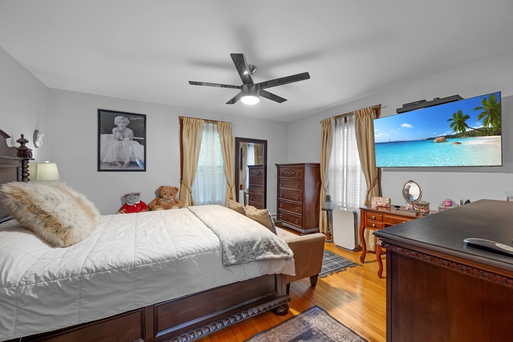 156 Olean Street Worcester, MA 01602 - Photo 16 of 37 a bedroom with a bed and a dresser with wooden floor