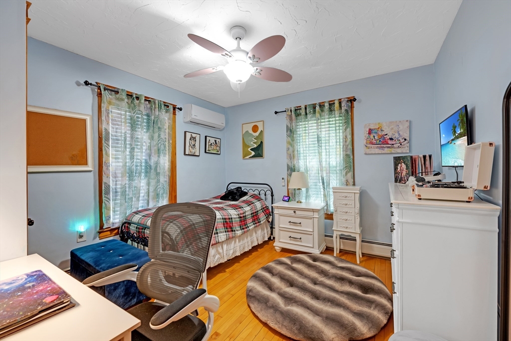156 Olean Street Worcester, MA 01602 - Photo 20 of 37 a bedroom with a bed and wooden floor