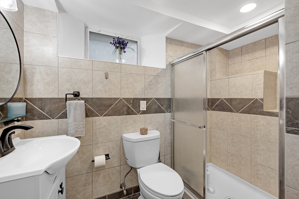 156 Olean Street Worcester, MA 01602 - Photo 24 of 37 a bathroom with a sink a toilet and shower