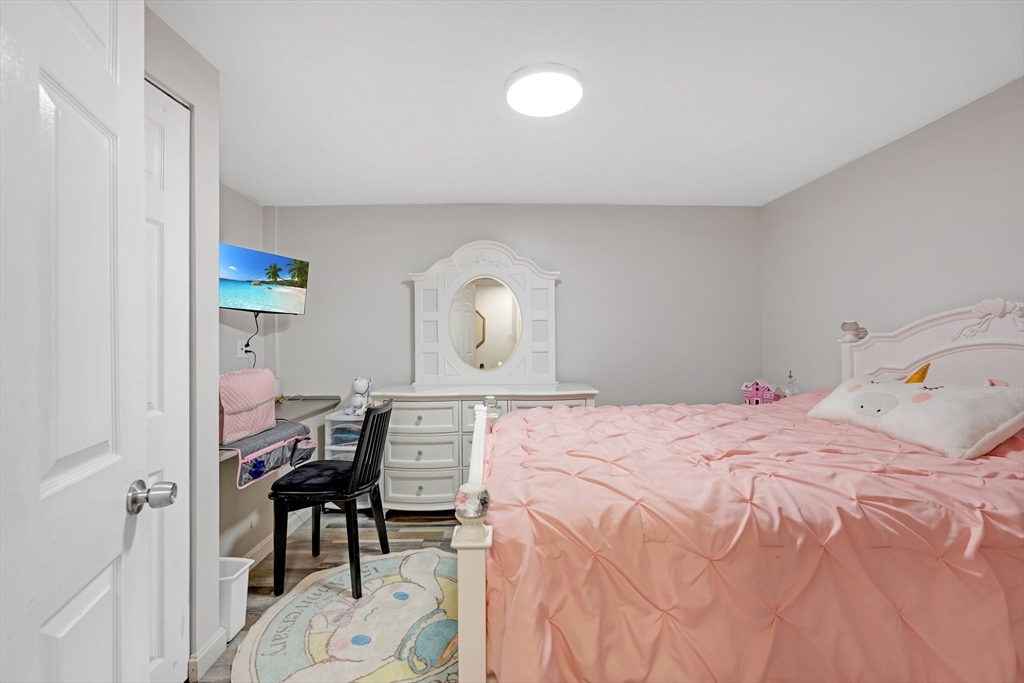 156 Olean Street Worcester, MA 01602 - Photo 26 of 37 a bedroom with a bed and a table in it