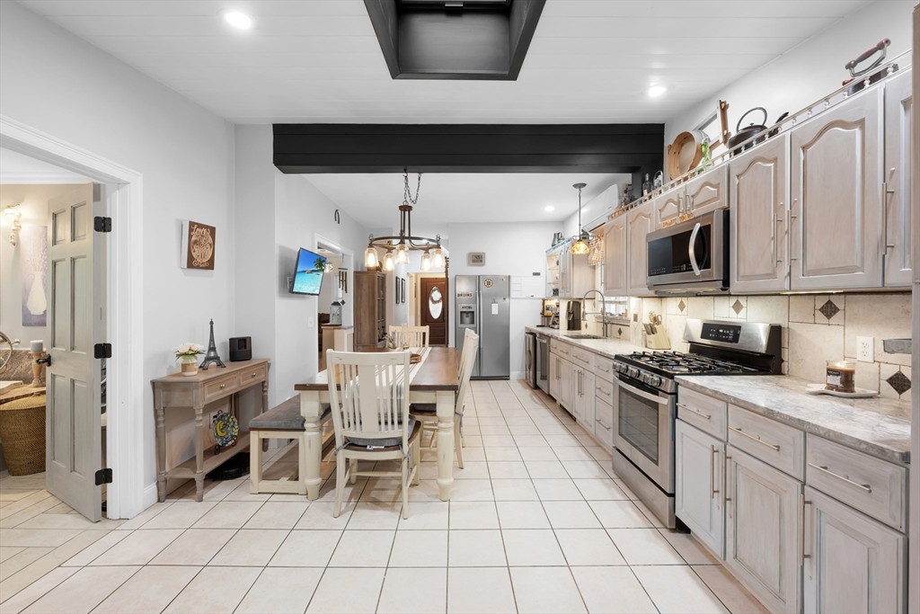 156 Olean Street Worcester, MA 01602 - Photo 8 of 37 a kitchen with stainless steel appliances kitchen island granite countertop a sink and cabinets