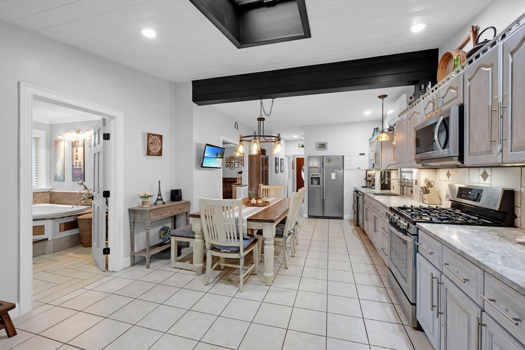 156 Olean Street Worcester, MA 01602 - Photo 9 of 37 a kitchen with stainless steel appliances kitchen island granite countertop a sink and cabinets