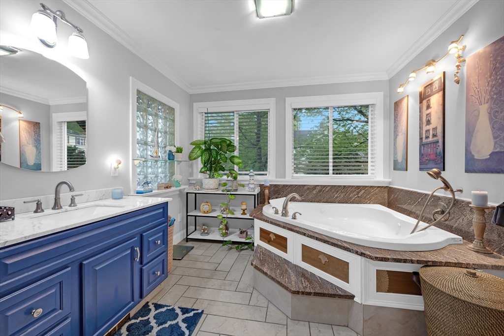 156 Olean Street Worcester, MA 01602 - Photo 10 of 37 a spacious bathroom with a granite countertop tub sink and mirror