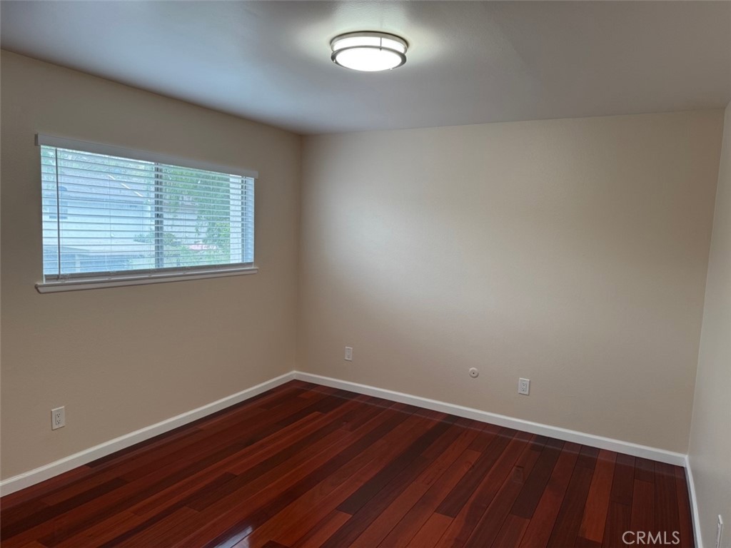 1115 Clark Street Riverside, CA 92501 - Photo 14 of 24 an empty room with wooden floor and windows
