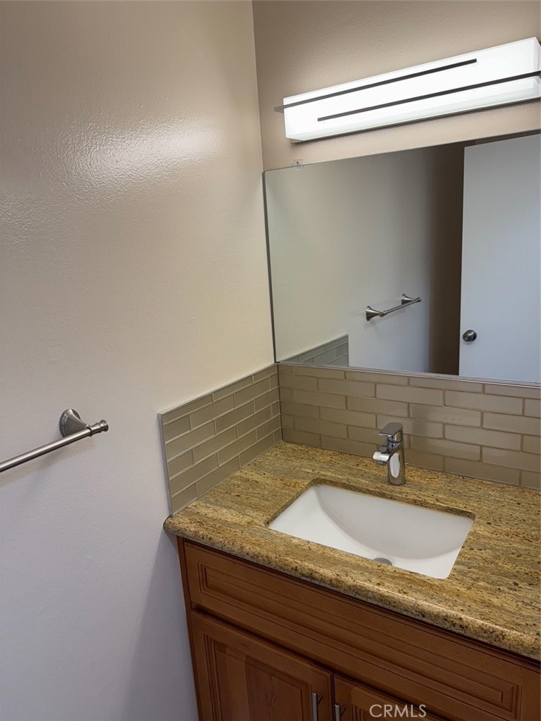 1115 Clark Street Riverside, CA 92501 - Photo 16 of 24 a bathroom with a granite countertop sink and a mirror