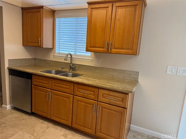 a kitchen with stainless steel appliances granite countertop cabinets and sink