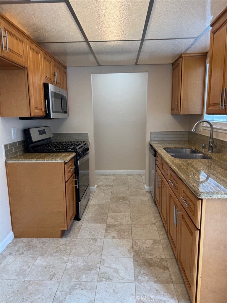 1115 Clark Street Riverside, CA 92501 - Photo 5 of 24 a kitchen with stainless steel appliances granite countertop a stove a sink and a microwave