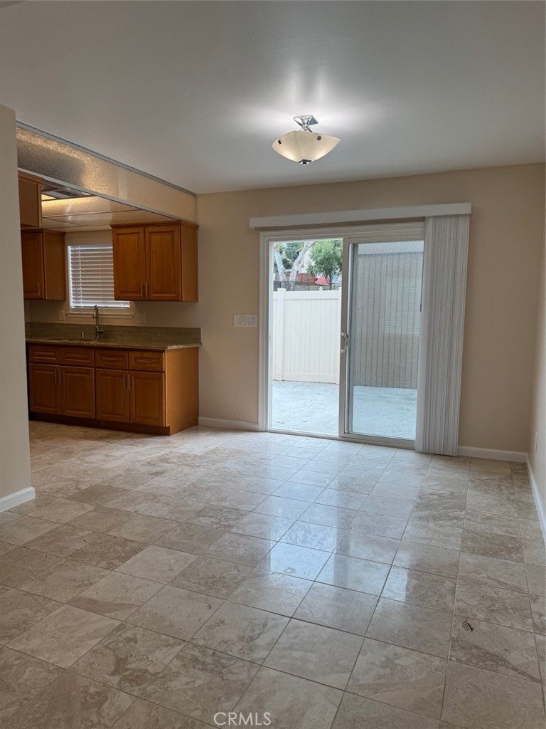 1115 Clark Street Riverside, CA 92501 - Photo 6 of 24 a view of an empty room with a kitchen