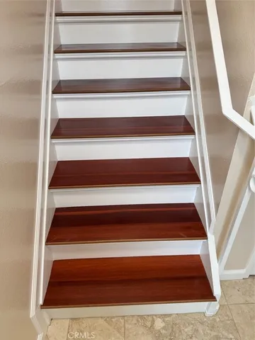 a view of a room with wooden floor and windows
