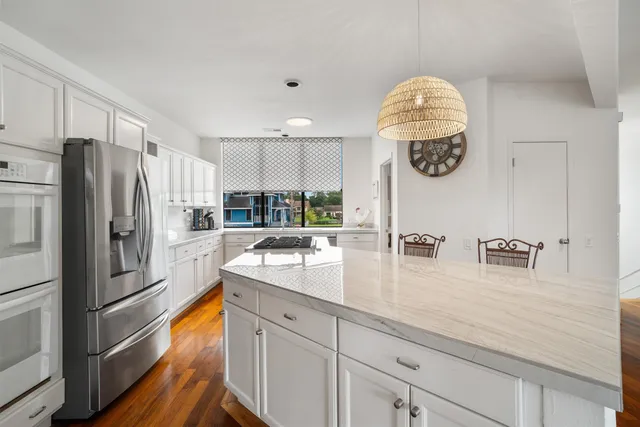 a kitchen with cabinets and wooden floors