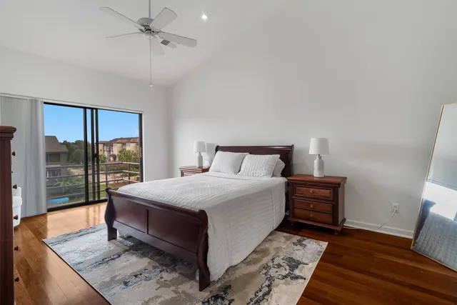 a bedroom with a bed and large window