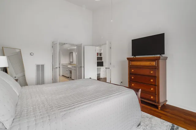 a bedroom with a bed and a flat screen tv