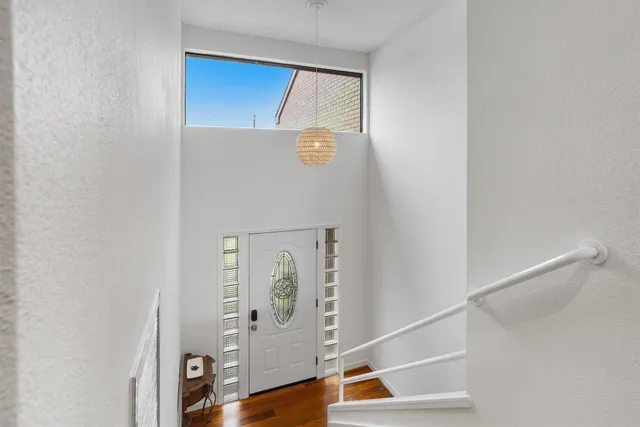 a view of an entryway with wooden floor